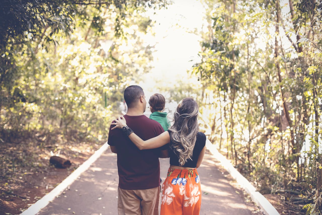 photo-of-family-walking-on-park