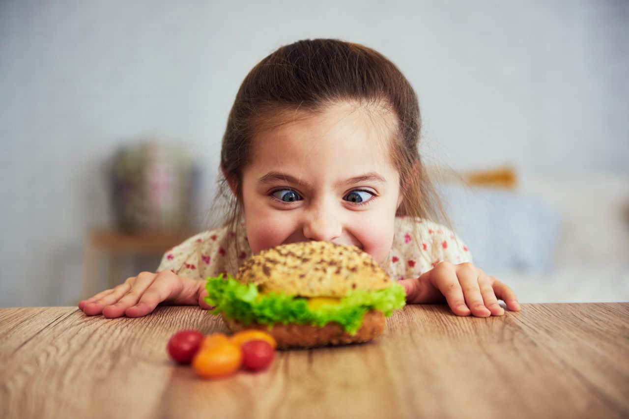 playful-girl-looking-delicious-hamburger